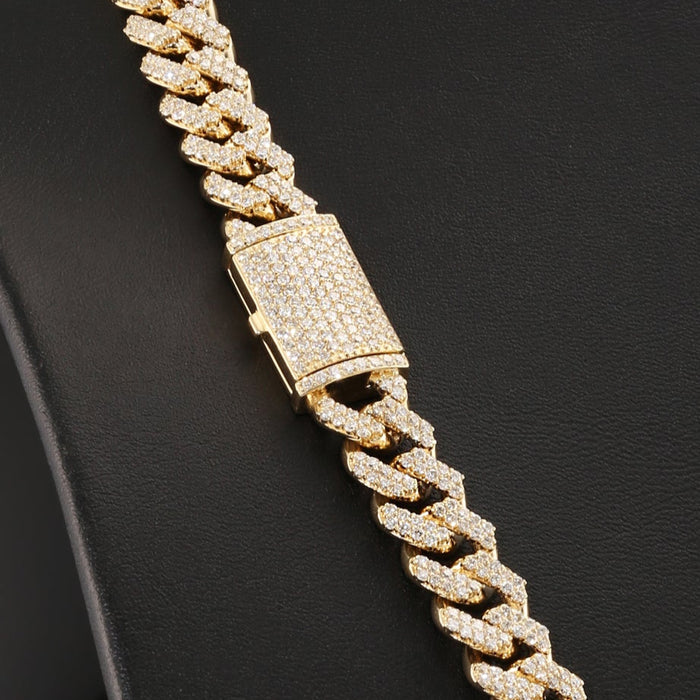 Gold chain necklace on a black mannequin bust.